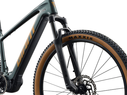 Close-up of a bicycle frame with 'Maxxis' tire on a white background