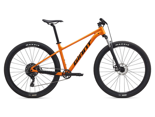 Orange bicycle with black components on a white background