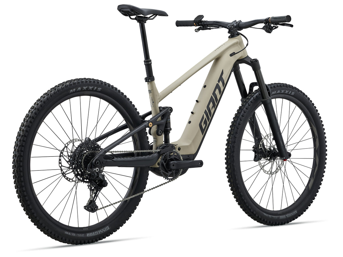 Beige electric bike with black components on a white background