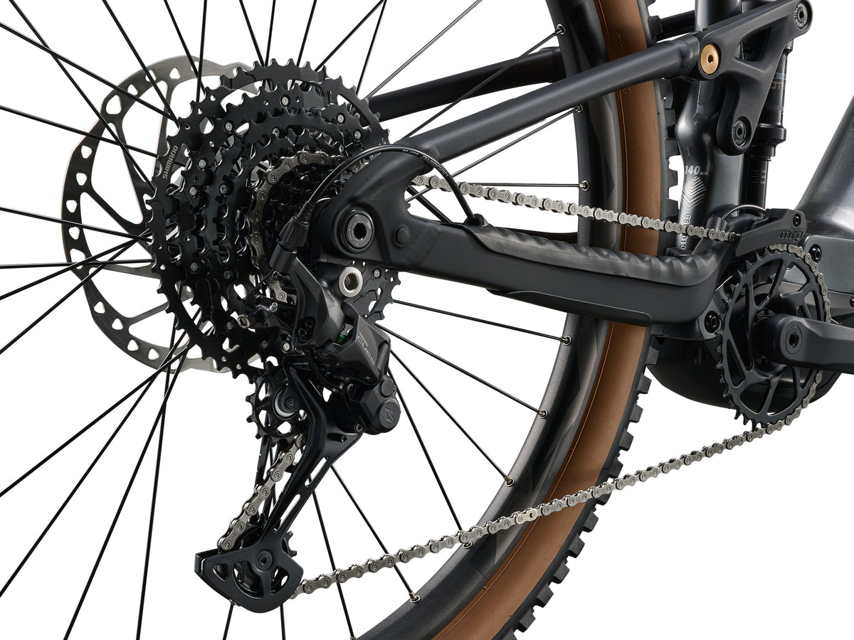 Close-up of a bicycle's rear wheel and gear system on a white background