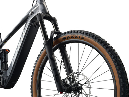 Close-up of a bicycle wheel with Maxxis tire on a white background