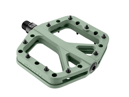 Green bicycle pedal with multiple mounting holes on a white background