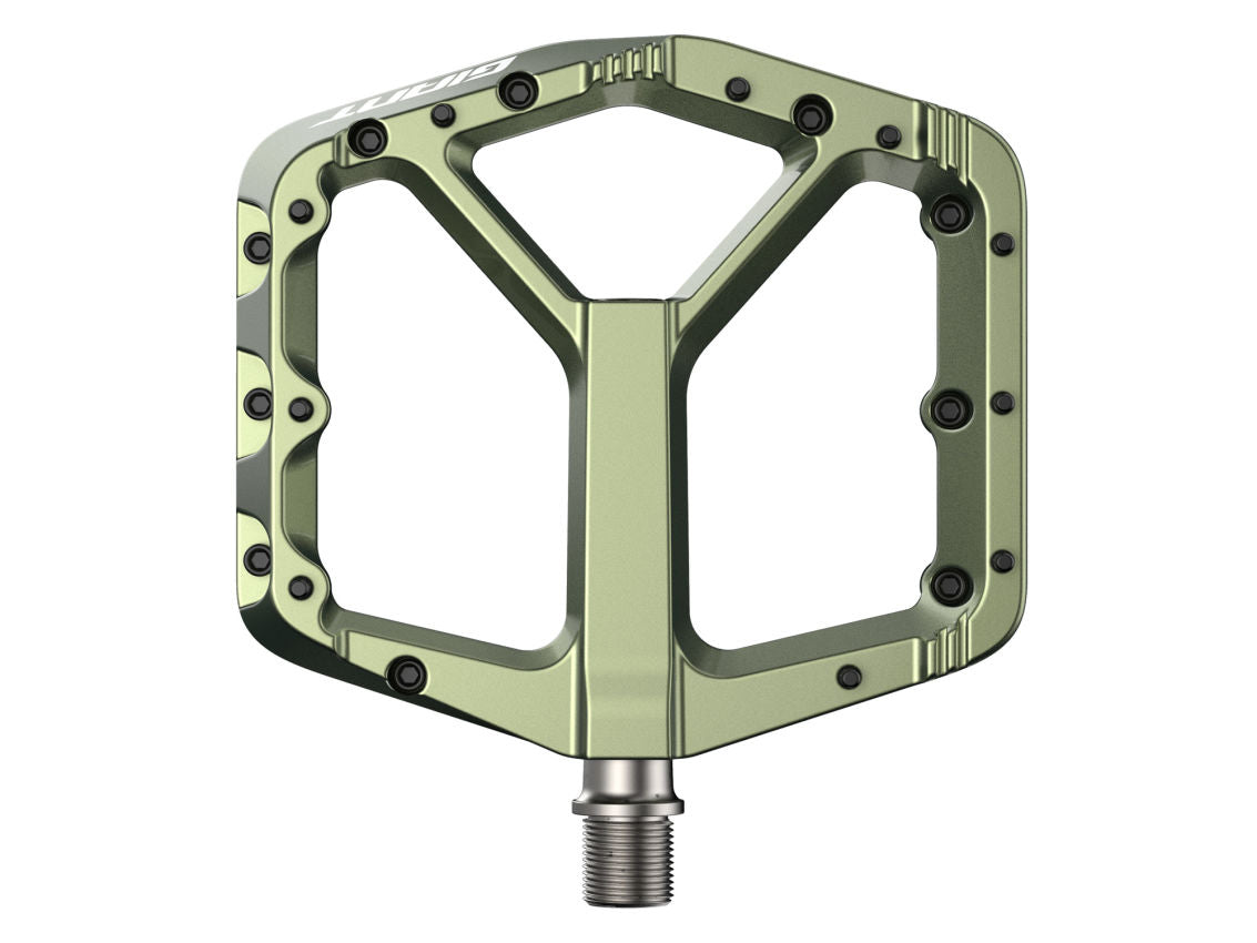Green bicycle pedal with metallic finish on a white background
