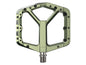 Green bicycle pedal with metallic finish on a white background