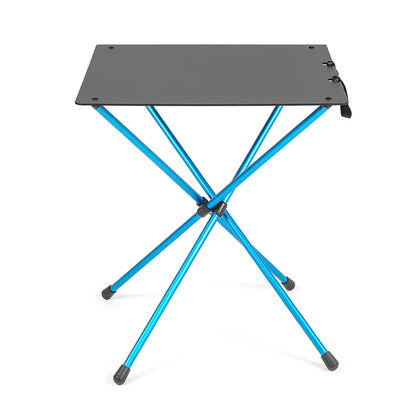 Portable folding table with blue legs and black top on a white background