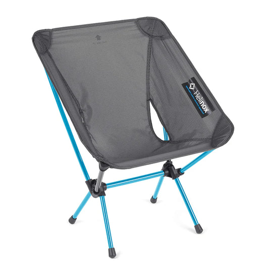 Portable camping chair with blue legs and black mesh seat on a white background