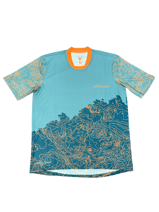A short-sleeve athletic t-shirt with a teal and blue topographic map print, featuring an orange collar and a small white logo on the chest.