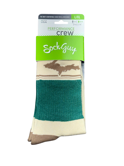 A packaged pair of crew socks from Sock Guy, featuring a green and white header card with 'PERFORMANCE crew' and 'SockGuy' branding. The socks have a cream base with a brown silhouette graphic and a prominent dark green stripe.