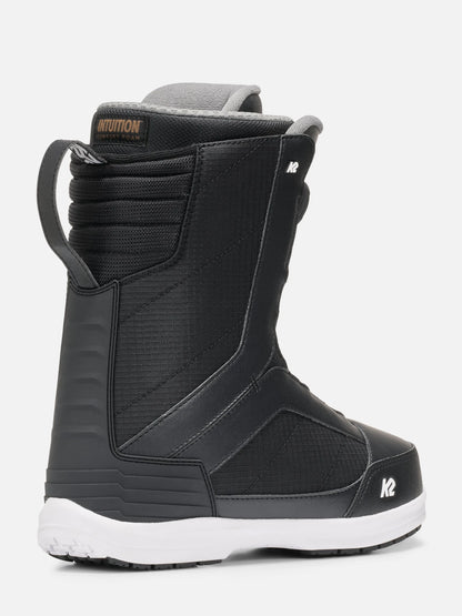 A black snowboard boot with a white sole, featuring a textured synthetic upper, a gray inner collar, and a white logo on the toe area, shown against a light gray background.