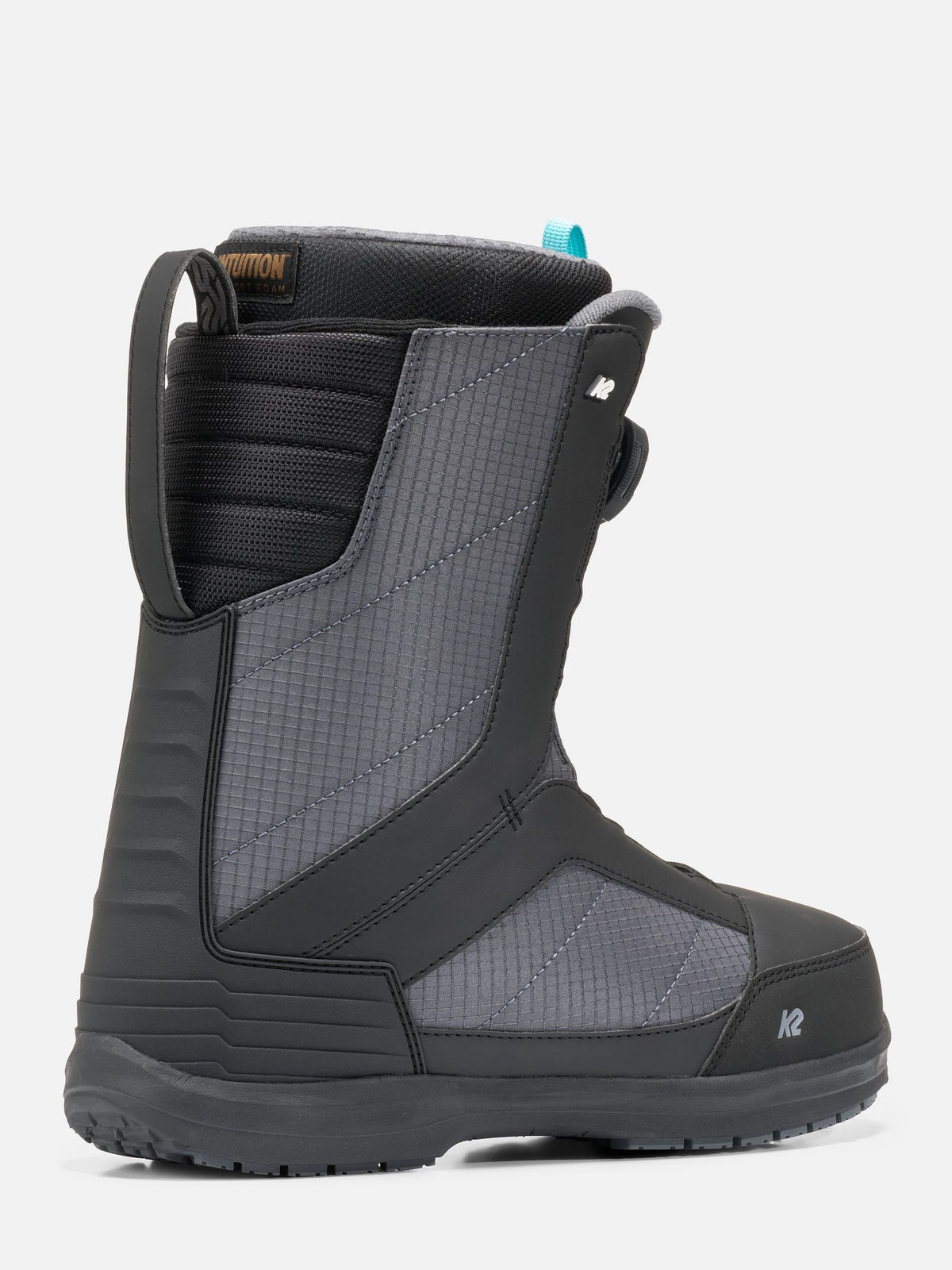 A single snowboard boot in dark gray and black with textured panels, a pull tab, and a small blue accent near the collar, shown on a light gray background.