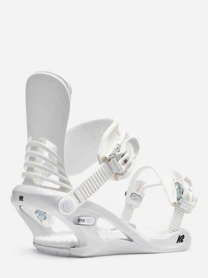 A pair of white snowboard bindings, shown against a clean, light off-white background. The bindings feature white straps, buckles, and a white base with small silver and black details.