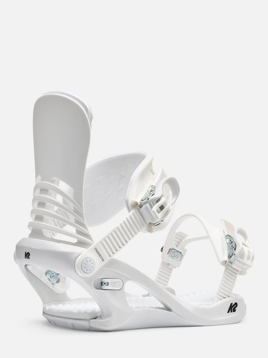 A pair of white snowboard bindings, shown against a clean, light off-white background. The bindings feature white straps, buckles, and a white base with small silver and black details.