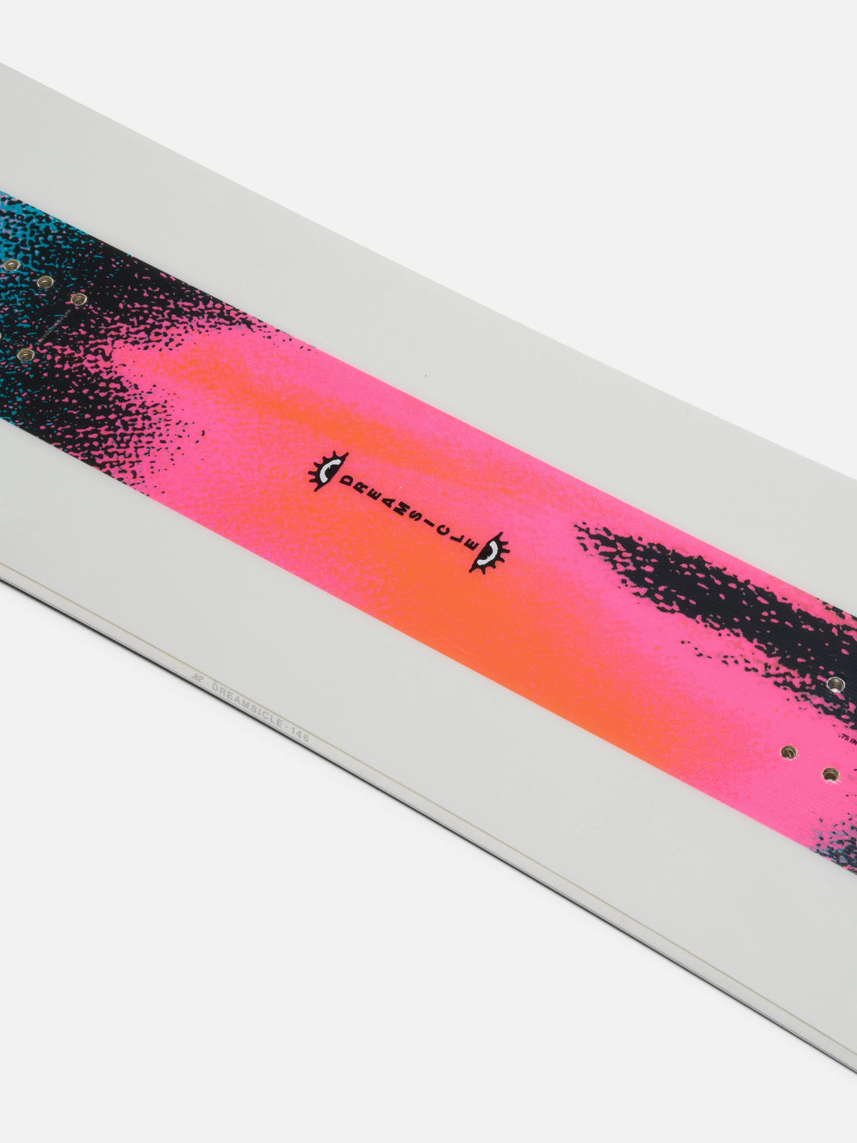A close-up of a snowboard top sheet strip featuring a vibrant pink and orange gradient with black textured paint splatters and small black graphics, mounted on a white snowboard base.