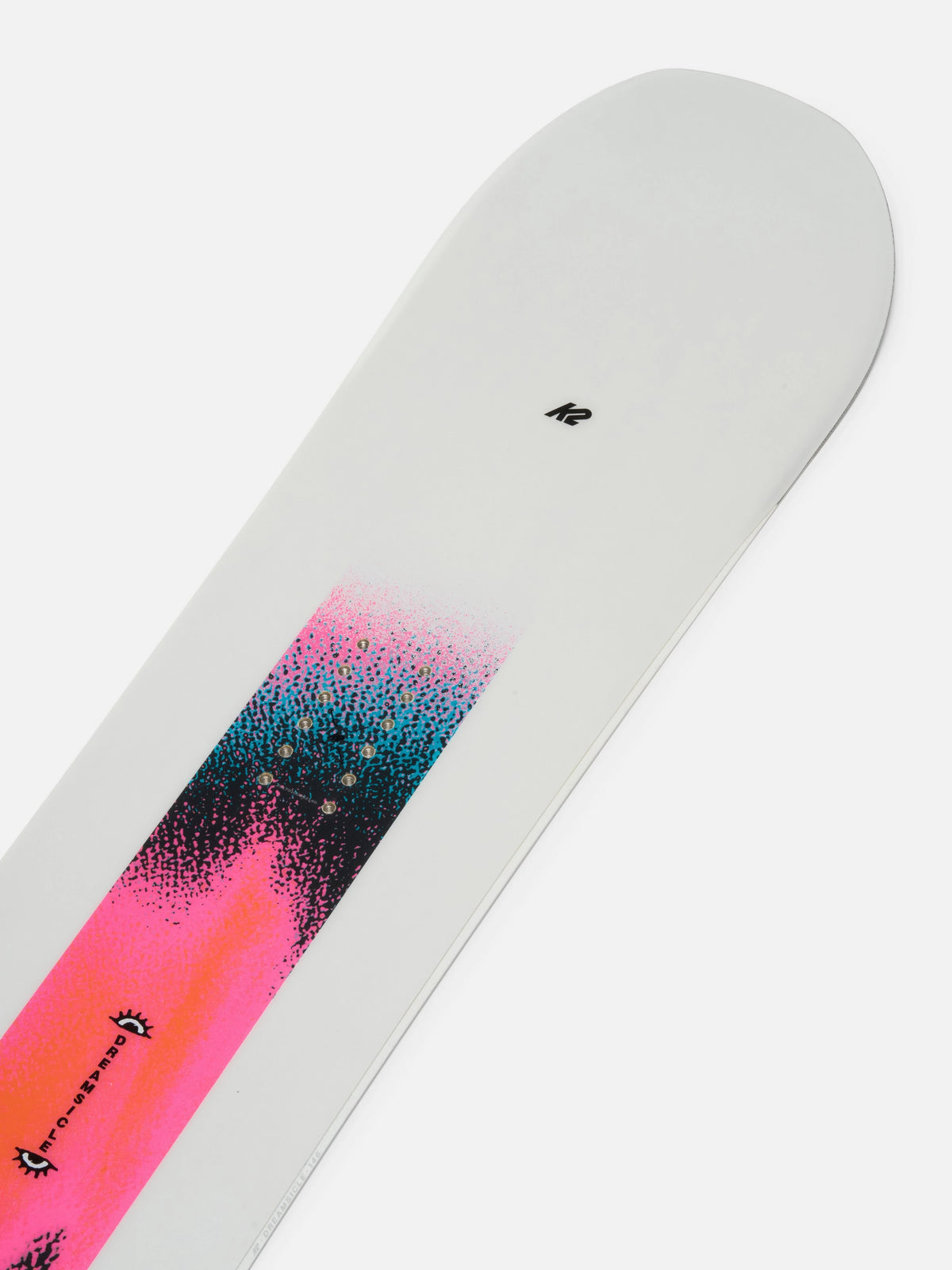 A close-up of a snowboard tail showing a white base with a vibrant pink, teal, and black graphic design and a small black logo near the top.
