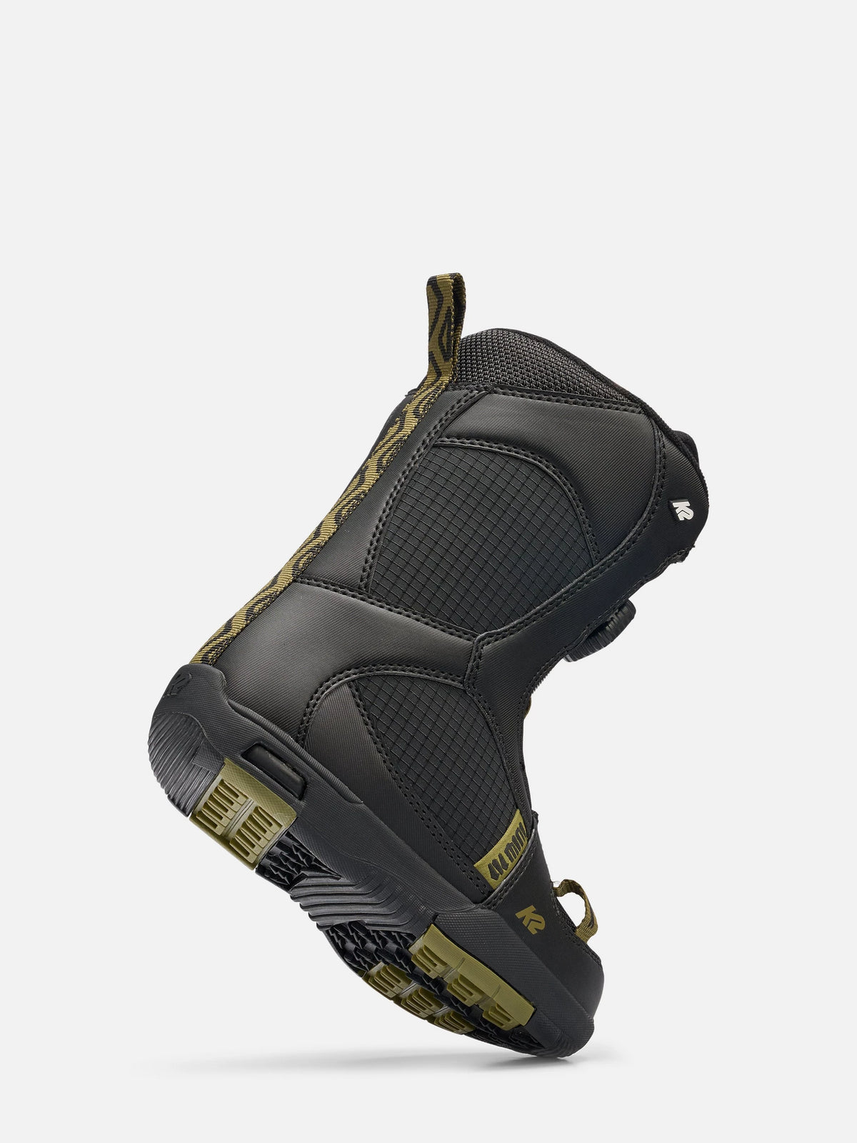 A black mid-cut athletic boot with olive green accents on the sole, pull tabs, and side detailing, shown from a three-quarters angle against a light gray background.