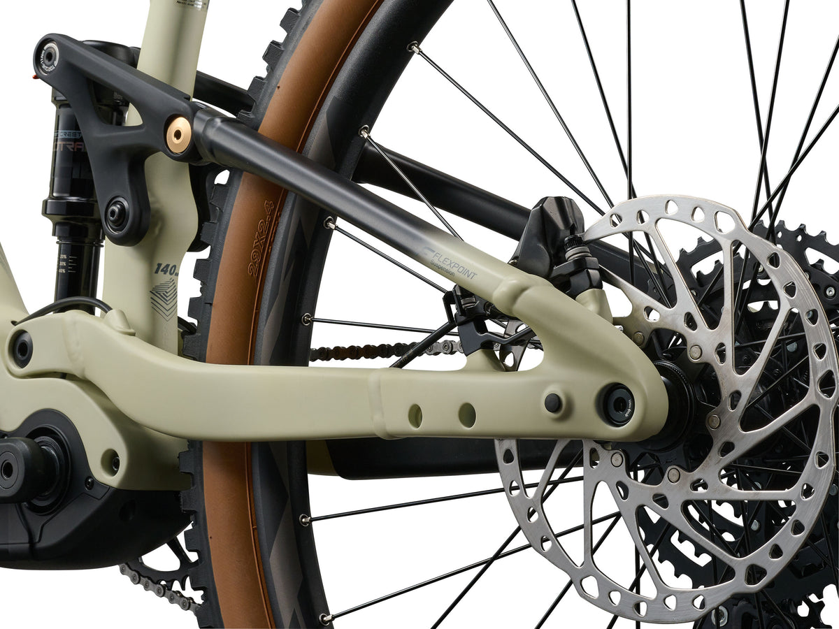 Close-up of a bicycle's chain mechanism and disc brake on a white background