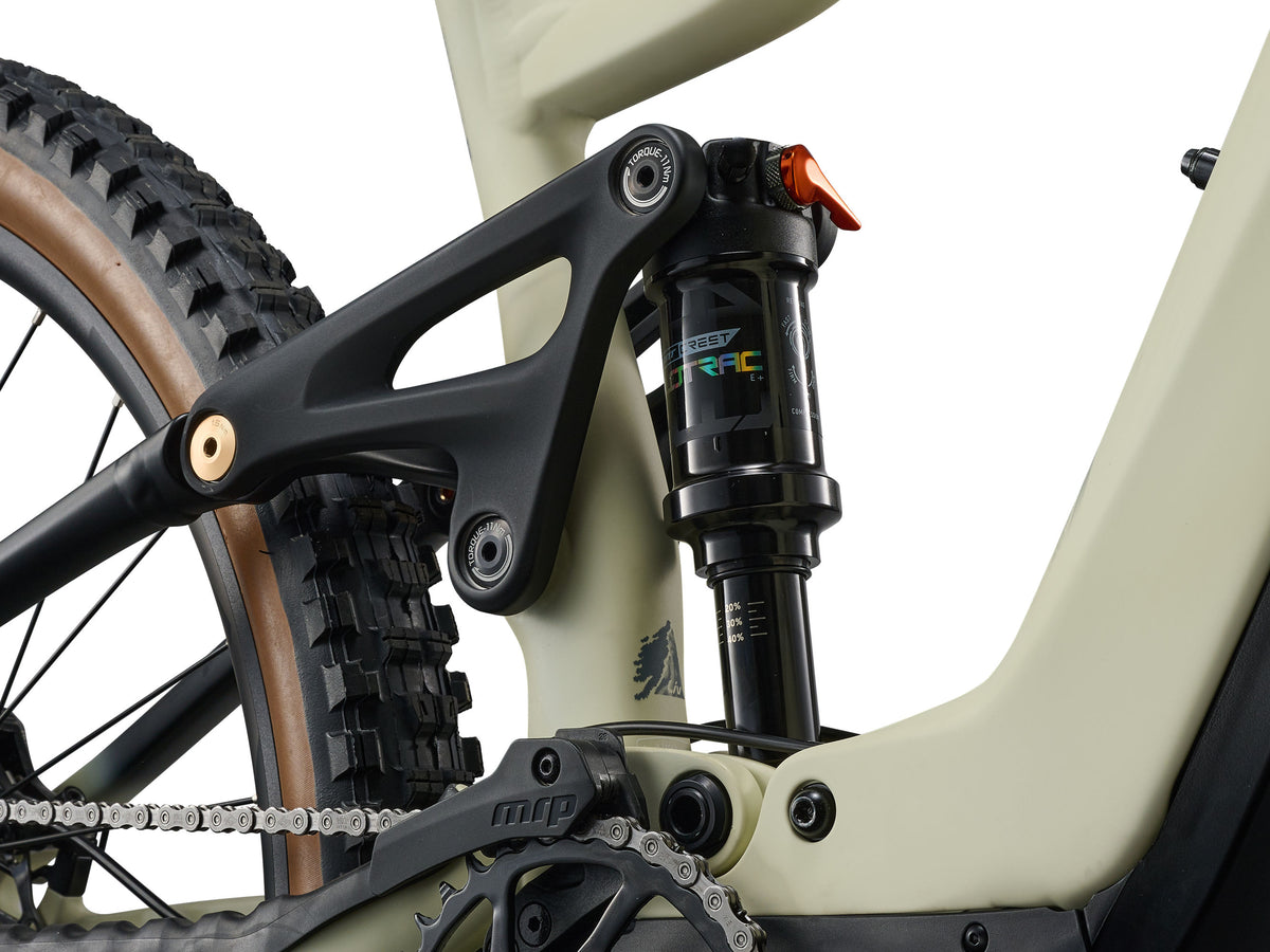 Close-up of a bicycle suspension fork and chain on a white background
