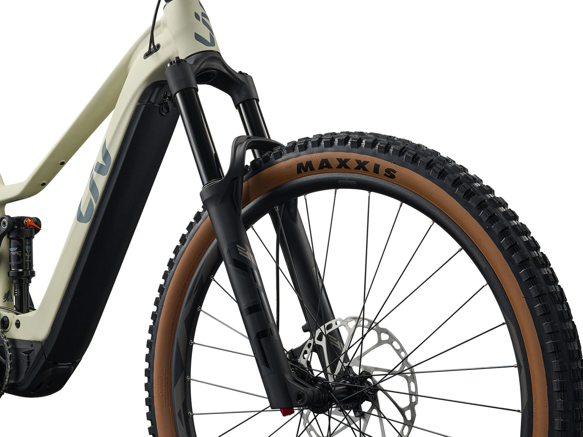 Close-up of a bicycle wheel with Maxxis tire on a white background