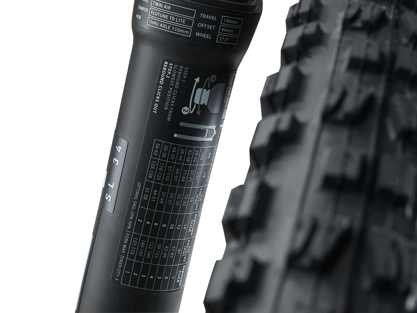 Close-up of a bicycle tire with tread pattern and sidewall details on a white background