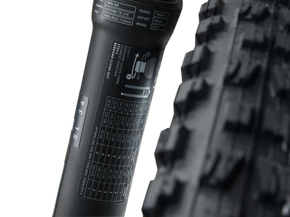 Close-up of a bicycle tire with tread pattern and sidewall details on a white background