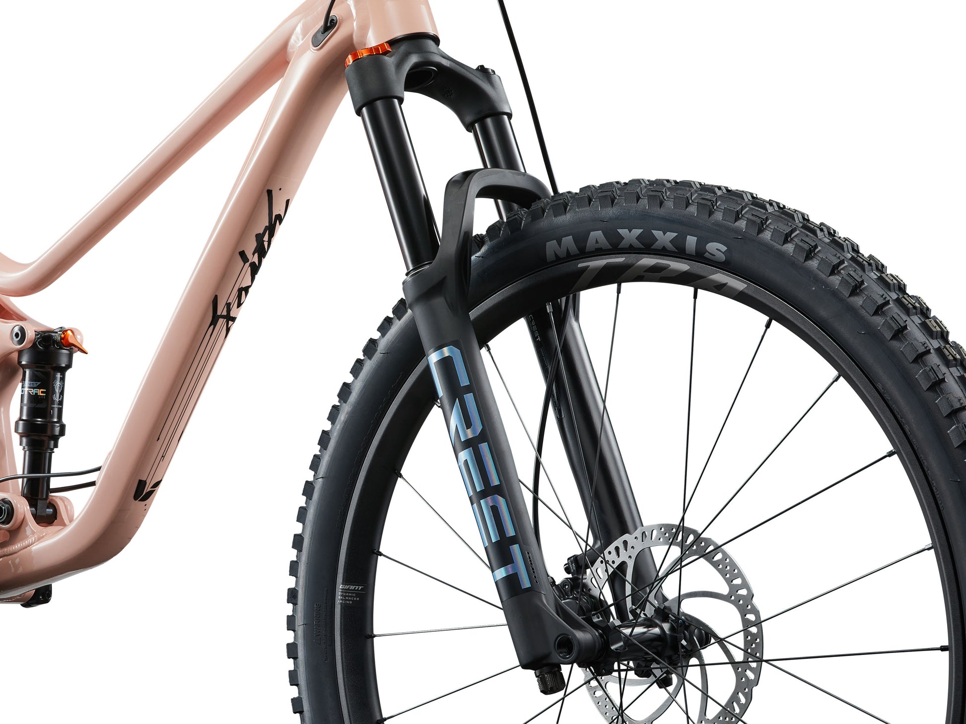 Close-up of a bicycle with 'Crest' branding on the fork and 'Maxxis' tire.