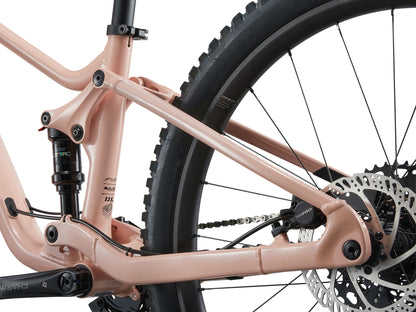 Close-up of a pink bicycle frame with visible components on a white background