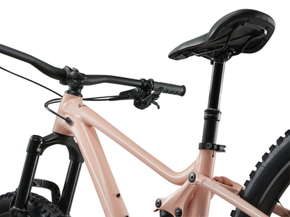Close-up of a pink bicycle with black handlebars and seat on a white background