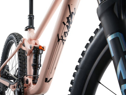 Close-up of a bicycle with a brand logo on the frame against a white background