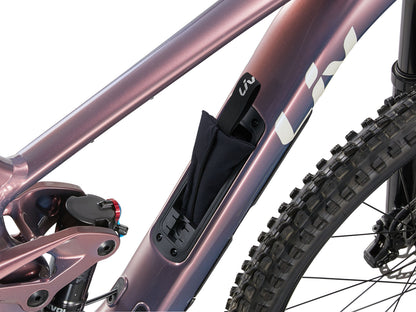 Close-up of a bicycle frame with a black bag attached on a white background