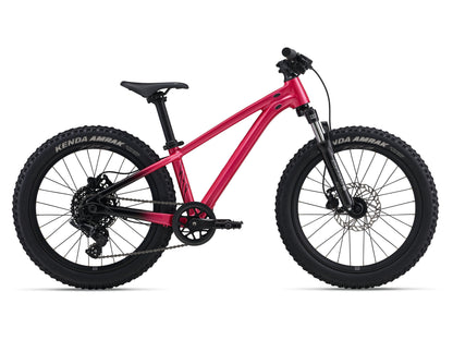 Pink children's bike with black tires on a white background