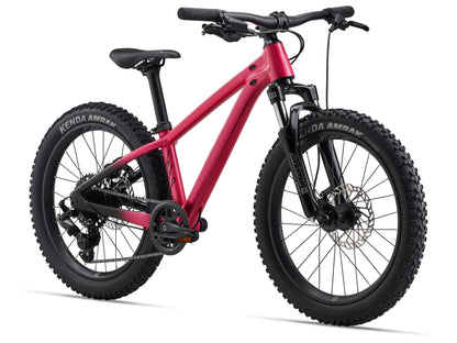 Pink children's bicycle with black tires on a white background