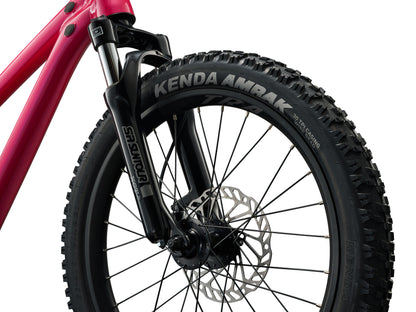 Close-up of a bicycle wheel with Kenda Ambra tire on a white background
