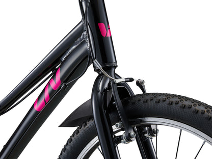 Close-up of a black bicycle with pink branding on a white background