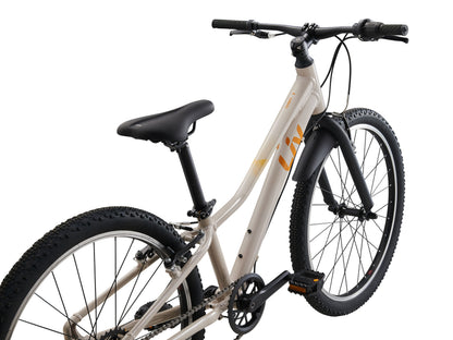 White children's bicycle with black tires and seat on a white background