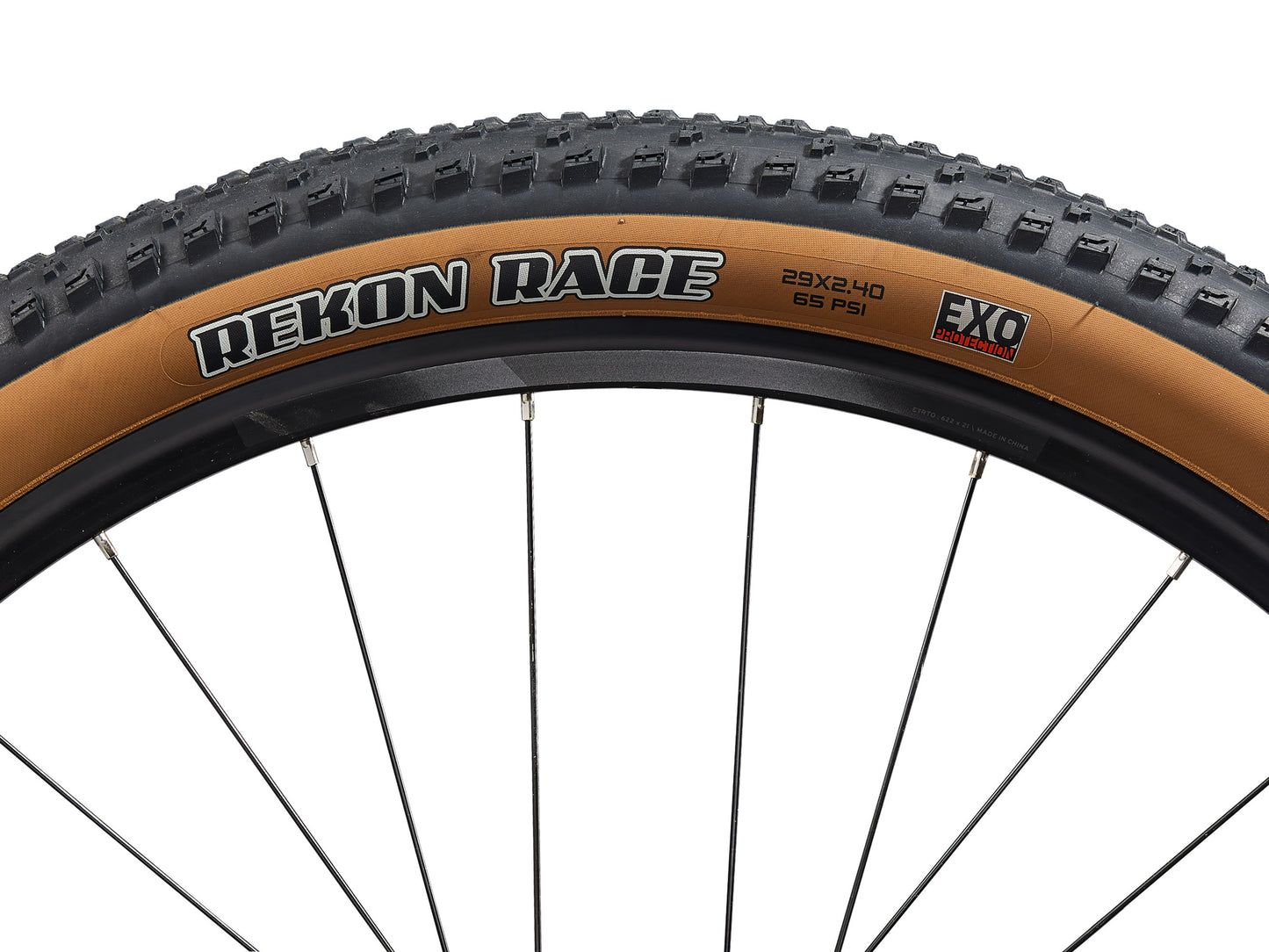 Close-up of a bicycle tire with 'Rekon Race' branding on a white background