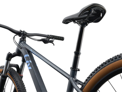 Close-up of a bicycle with a black frame and brown tires on a white background
