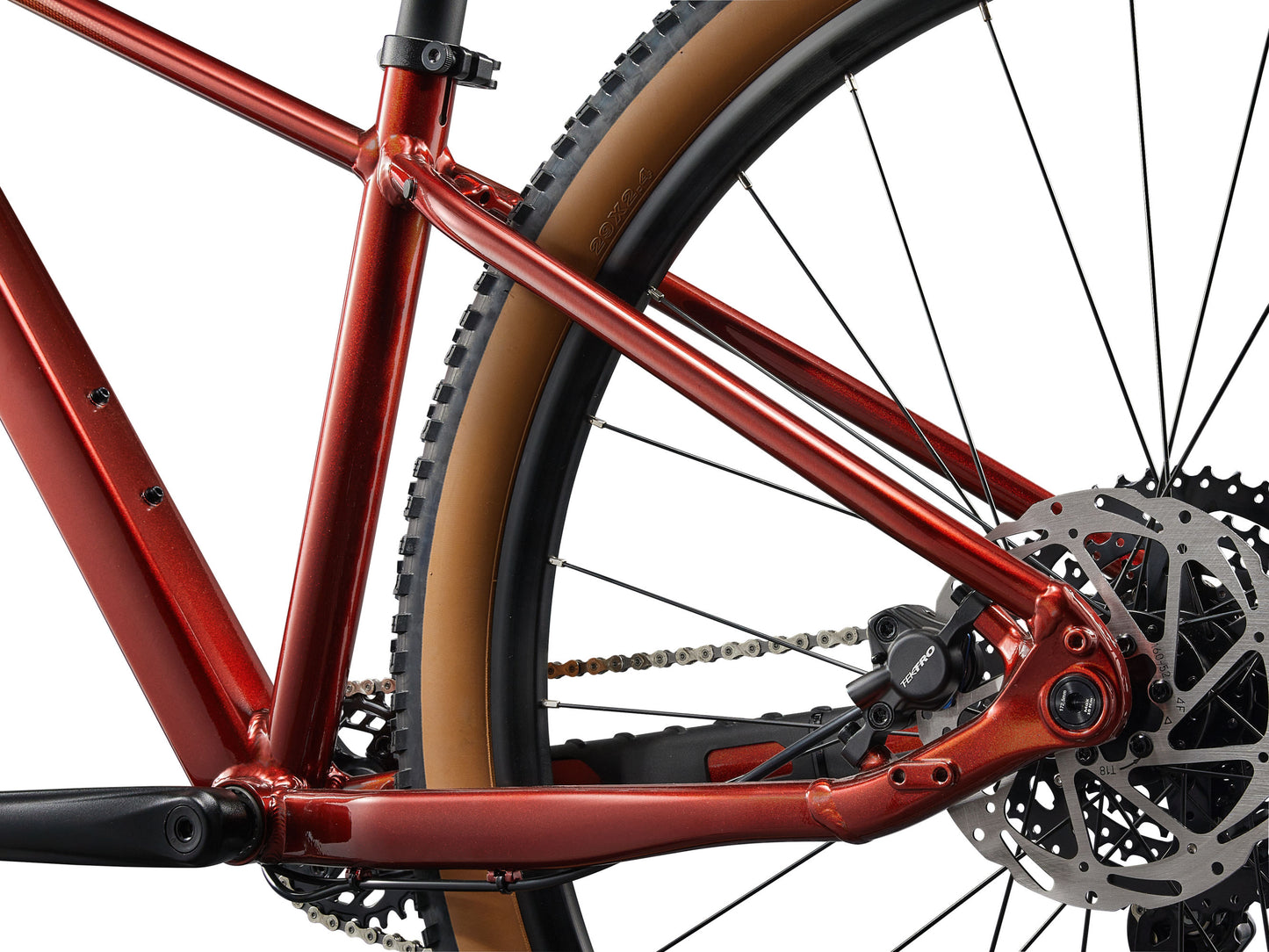 Close-up of a red bicycle frame with chain and gears on a white background