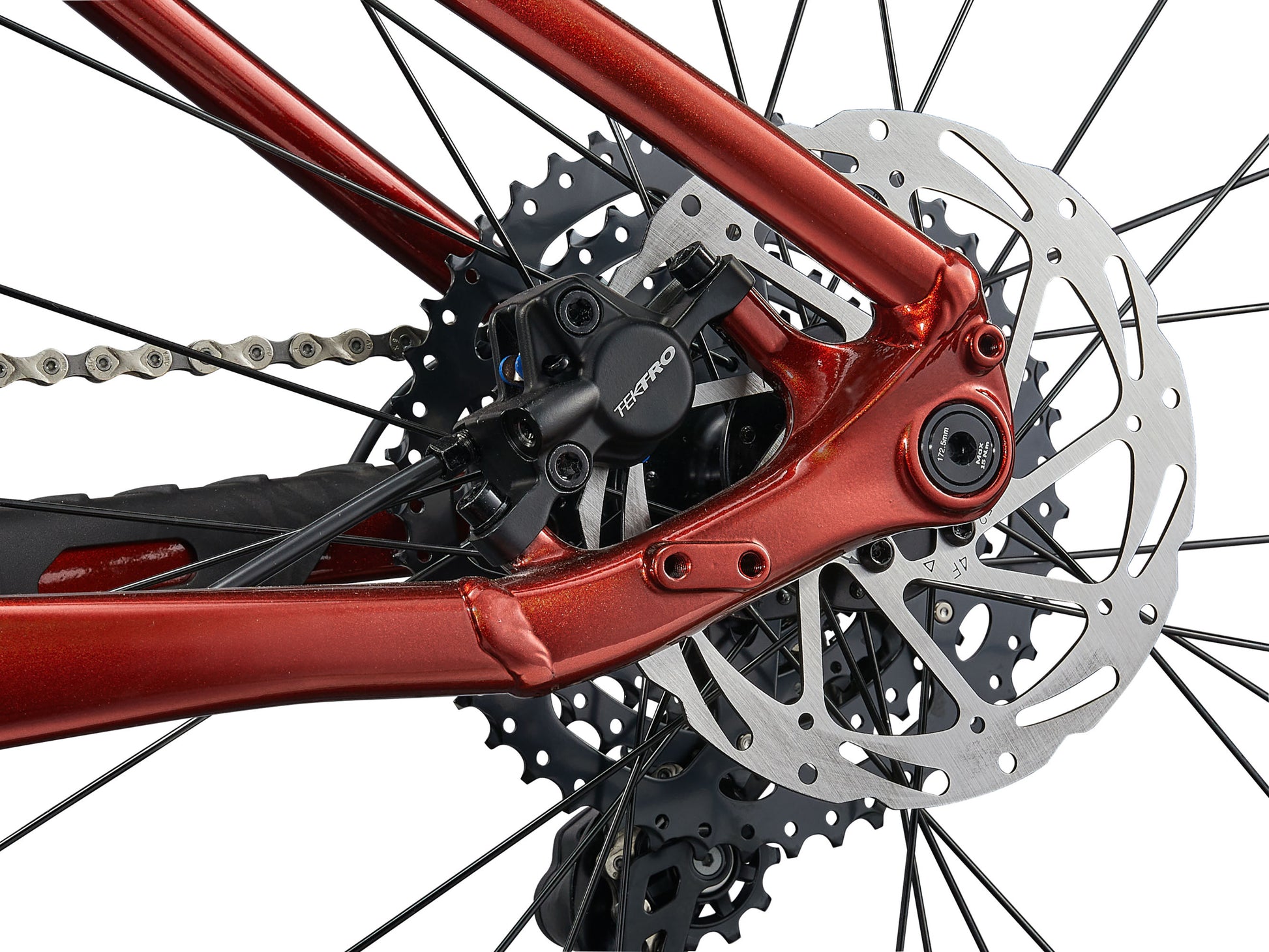 Close-up of a bicycle's chain mechanism with red metal components.