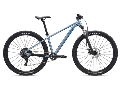Blue mountain bike with Maxxis tires on a white background