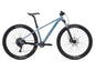Blue mountain bike with Maxxis tires on a white background