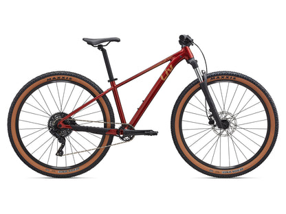 Red mountain bike with brown tires on a white background