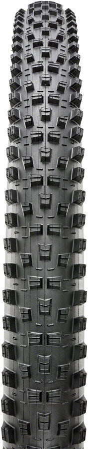 Close-up of a tire tread pattern with prominent knobs on a black background