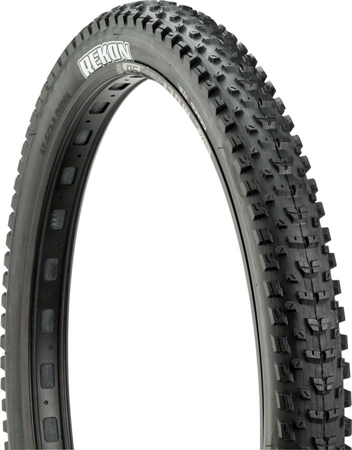 Black off-road tire with tread pattern on a white background