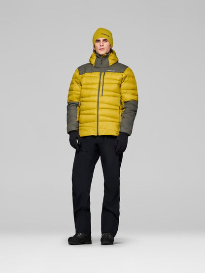 Person wearing a yellow and gray puffer jacket on a white background