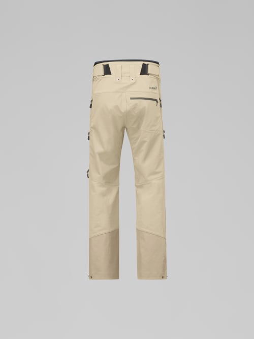 Beige work pants with zippers and straps on a gray background