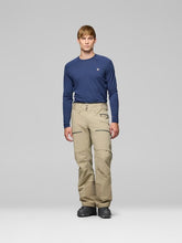 Load image into Gallery viewer, Man wearing a navy long-sleeve shirt and beige pants on a gray background

