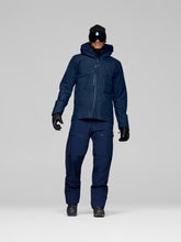 Load image into Gallery viewer, Person wearing a navy blue winter suit with a hood on a light gray background
