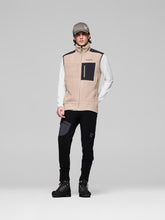 Load image into Gallery viewer, Person wearing a beige vest with black accents on a gray background
