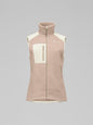 Pink fleece vest with a white patch on a gray background