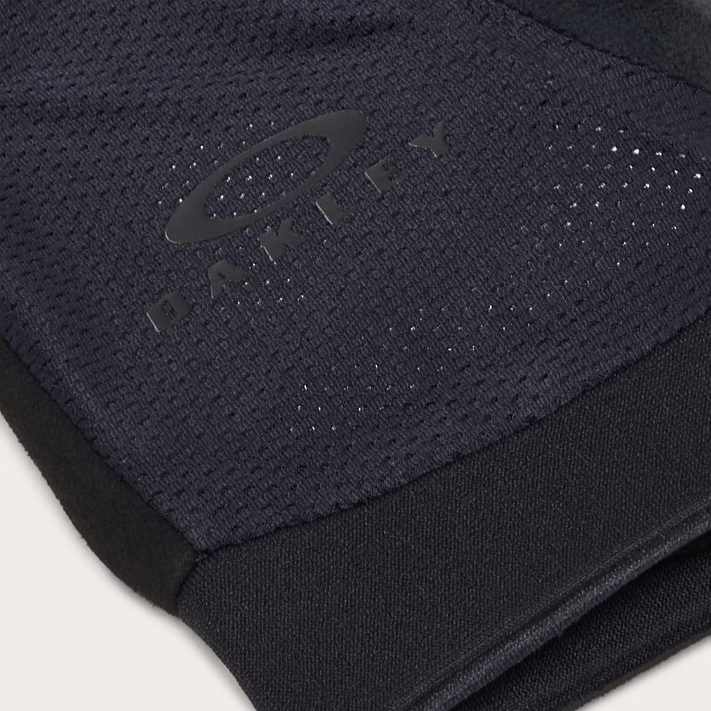 Close-up of a black sleeve with a brand logo on a white background